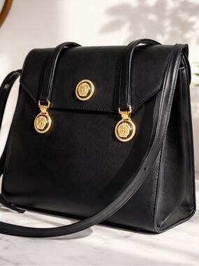 Versace Elegant Black Leather Handbag with Gold Medusa Accents.